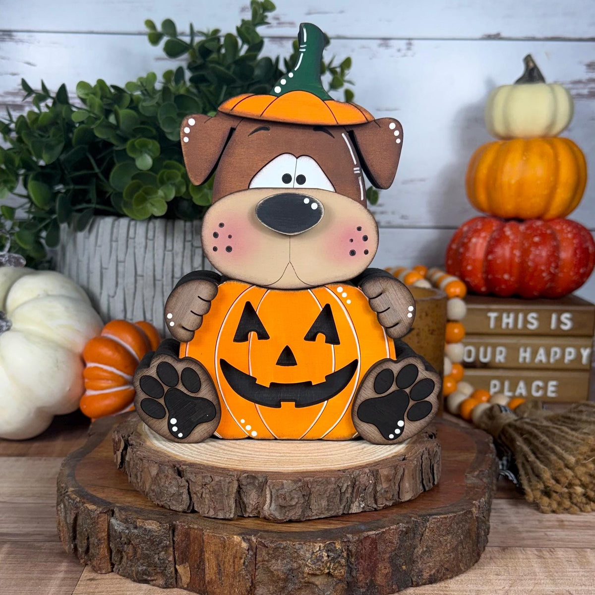 Hand painted wooden Halloween dog shelf sitter wearing an orange jack-o-lantern pumpkin costume